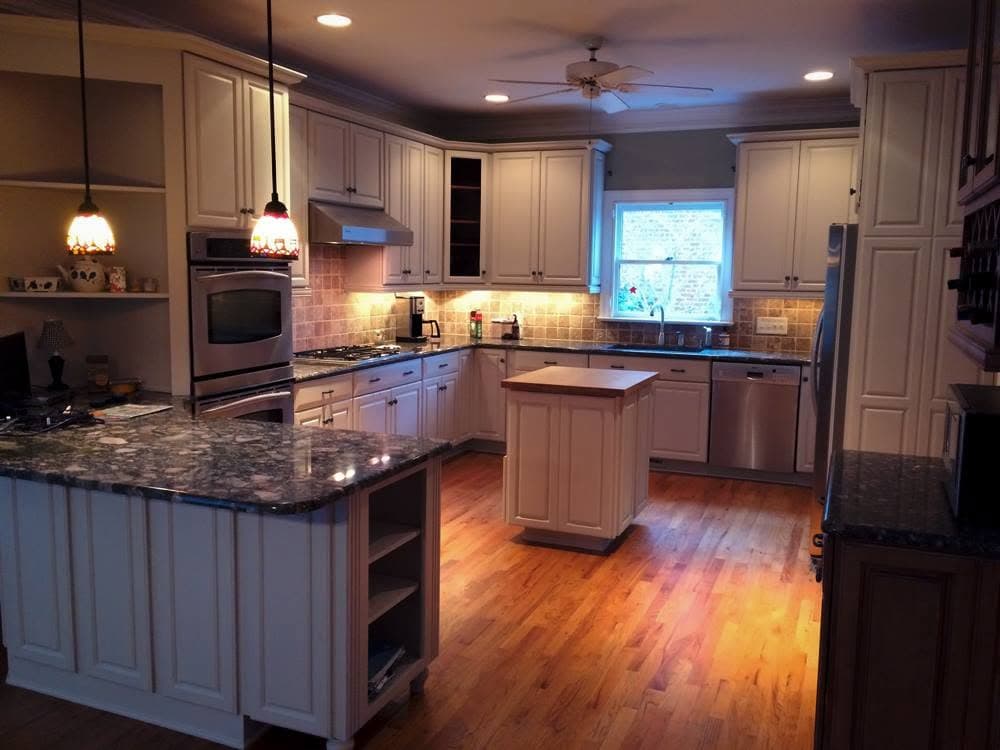 Finished kitchen with grey-painted cabinetry, granite worktops and a central island.